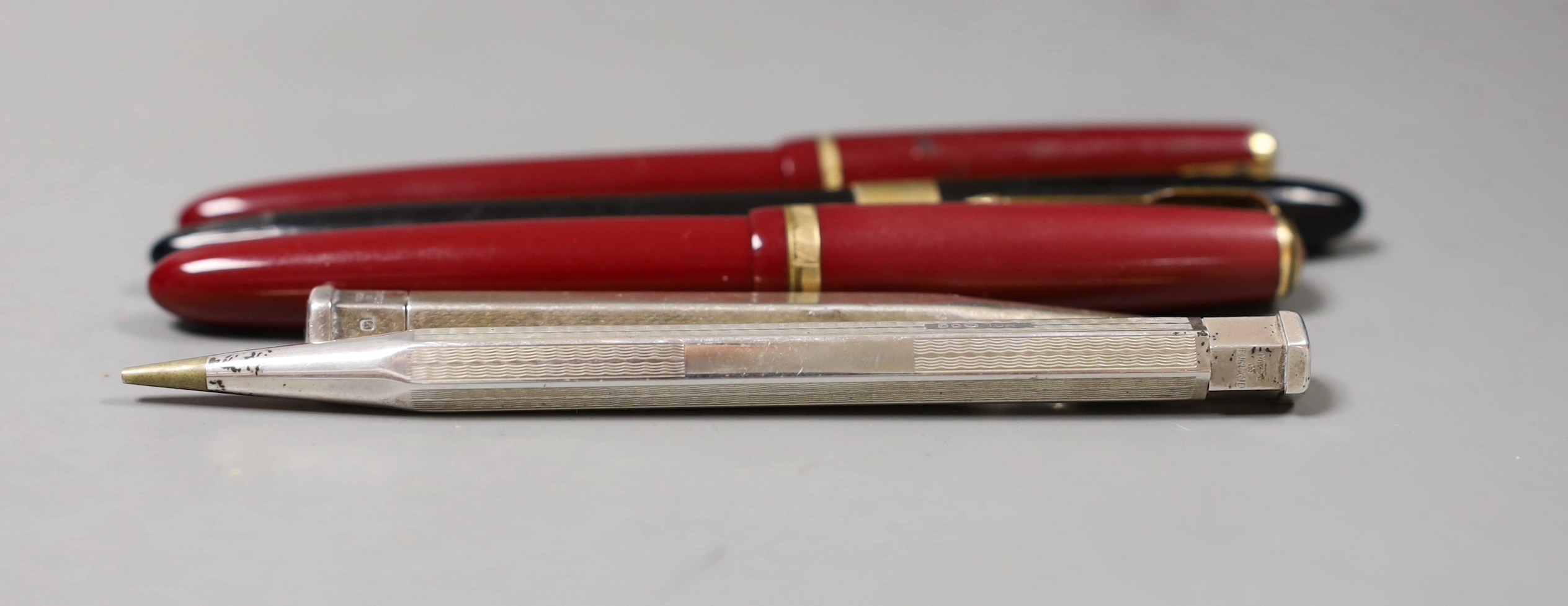 Two Parker fountain pens including Junior and three other pens or pencils including two silver cased.